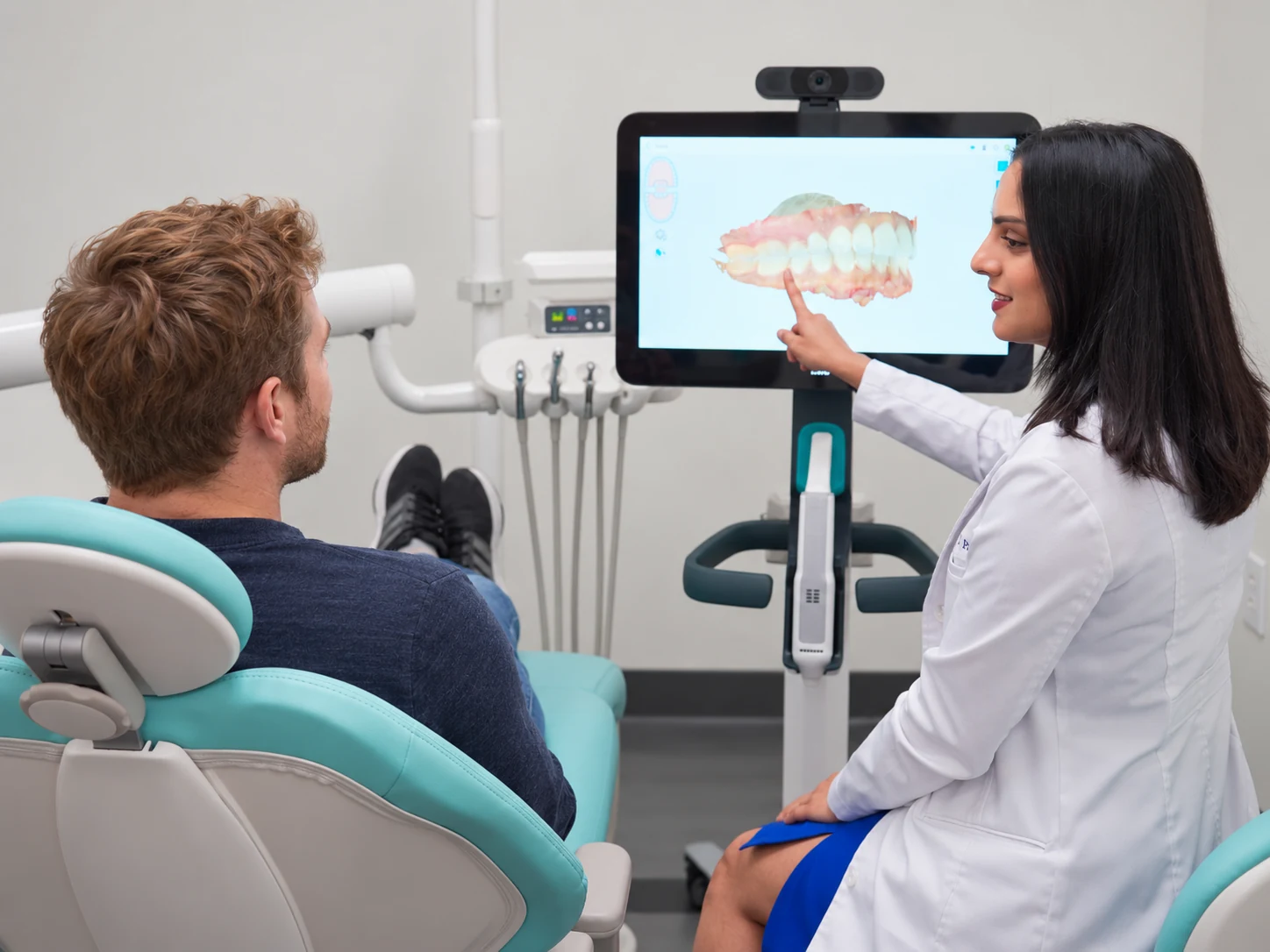 Dr. Vishala Patel showing a patient a 3D scan while planning dental implants at Edge Dental Designs in McKinney, TX