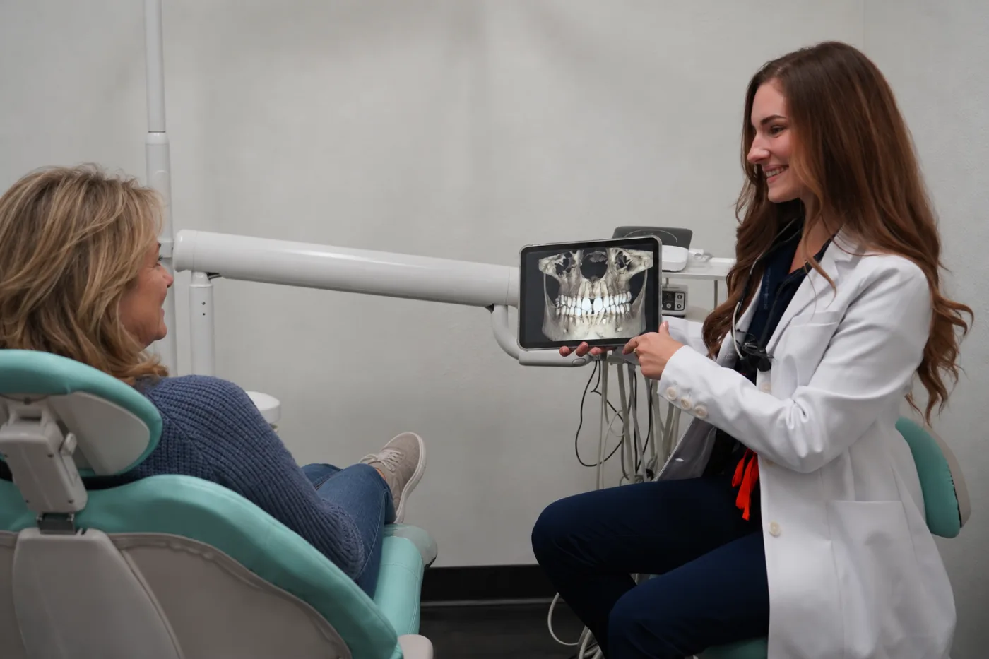 Dr. Elena Nemirovskii showing a patient a 3D dental scan in McKinney, TX