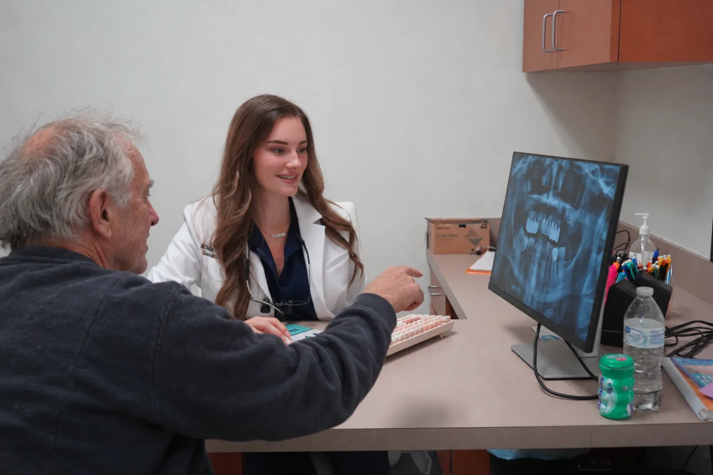 Dr. Elena Nemirovskii reviewing a panoramic X-ray with a patient